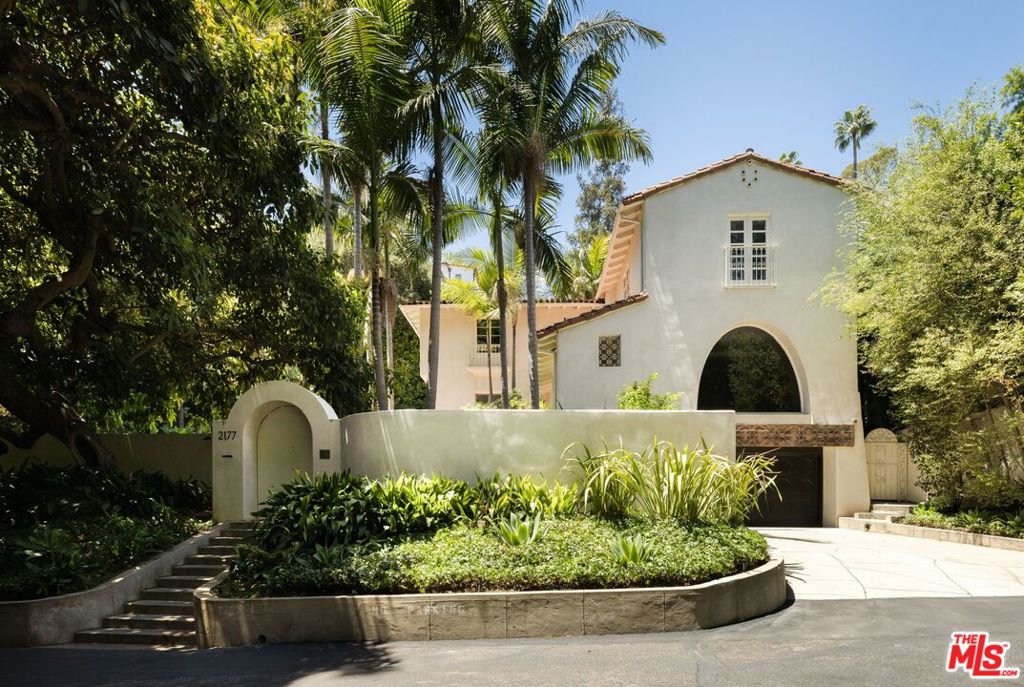 Tucked away on a private street at the base of the coveted Los Feliz Oaks, this breathtaking Spanish compound sits behind gates on an expansive double lot. Meticulously restored and tastefully updated, the home honors its architectural heritage while offering modern amenities including a screening room, wine cellar, pool, oversized steam room, and a state-of-the-art sound system. Multiple outdoor spaces designed for dining, lounging, and entertaining flow effortlessly from the interiors, creating a true sense of retreat and connection to the neighboring nature preserve. Just moments from Franklin Village and Los Feliz favorites: The Oaks Gourmet, La Poubelle, Little Dom's, Alcove, and more. The home sits at the gateway to Griffith Park with easy access to Hollywood, Burbank, Studio City, and Downtown LA. This is more than a home... it's a private sanctuary, brought back to life with care, style, and enduring character. A rare opportunity for those seeking space, seclusion, and authentic Spanish charm.