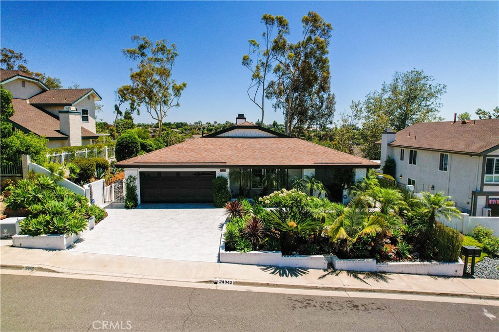 Welcome to this beautifully reimagined single-story home offering over 2,100 square feet of luxurious living space, located in the sought-after Stratford Ridge community, right next to the prestigious Nellie Gail Ranch. Perched on an oversized lot with breathtaking panoramic views, this rare gem combines elegance, comfort, and location—all with no HOA and a low tax rate. Step inside to an expansive, airy open-concept floor plan with soaring vaulted ceilings, abundant natural light, and top-tier finishes throughout. No detail has been overlooked! The home has been tastefully renovated! The newly constructed chef’s kitchen showcases an oversized island with storage, custom cabinetry, sleek countertops, and high-end appliances—perfect for entertaining or everyday living. Both spa-like bathrooms have been completely remodeled, and the home features new flooring, new drywall, new doors and windows, fresh interior and exterior paint, all new HVAC, water heater, and whole-house re-pipe—everything has been done for you. Enjoy the professionally landscaped backyard featuring beautiful mature plants and a variety of fruit trees, ideal for relaxing, entertaining, or gardening in your own private retreat. This turn-key home is a rare offering in a quiet, established neighborhood just minutes from beaches, top-rated schools, shopping, dining, and major freeways. Move right in and make 24942 Del Monte, Laguna Hills you next home! Stunning Fully Renovated Single-Story California Dream View Home in Stratford Ridge – No HOA & Low Tax Rate!