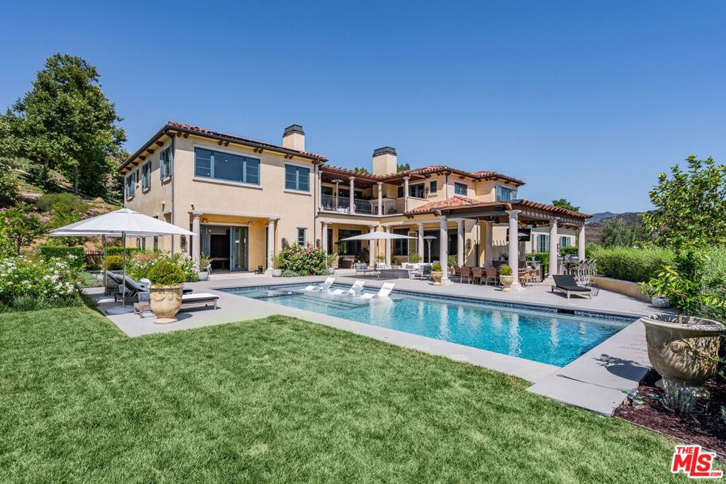 Sited within the gates of 'Malibu Valley Estates' amidst the picturesque Santa Monica Mountains, this newer-construction Mediterranean estate features breathtaking panoramic views, soaring 12-20ft+ ceilings, imported finishes and fixtures, and the utmost in security, privacy, smart-home innovation, and luxurious living by one of Southern California's most meticulous builders. Designed with no expense spared and set behind a 2nd set of gates within this exclusive 26-estate community enclave, "The Italianate," features a bespoke and grand open floor plan with over 7,000 sq ft of living space on just over 2 acres of land, 6 luxuriously appointed en-suite bedrooms and world-class amenities. Highlights include a dramatic foyer with soaring ceilings and handcrafted wrought iron, large-scale public rooms with walls of glass that perfectly frame the tranquil vistas, and a beautiful open floor plan with seamless indoor-outdoor flow. The chef's kitchen boasts professional-grade La Cornu and Gaggenau appliances, Carrera countertops and an oversized island with breakfast bar - ideal for casual dining. Experience the quintessential Southern California lifestyle, with a 20 ft retractable wall that opens to the loggia and resort-style backyard, complete with sparkling pool and spa, lush lawns, fountains and mature landscaping - reminiscent of a grand Villa in the heart of the Mediterranean, and perfect for entertaining on all scales with the most breathtaking backdrop. "The Italianate" showcases luxury living to its fullest potential, complete with a 4-car garage and expansive motor court - the ultimate space for car enthusiasts. Find yourself transported to the serenity and natural beauty of Malibu Valley. 10 minutes away from PCH, 5 minutes away from the US-101 - a lifestyle unlike any other.