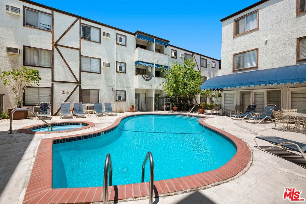 Stylish 1-Bed, 1-Bath Ground Floor Condo in the Heart of Tarzana! Welcome to this beautifully upgraded 1-bedroom, 1-bathroom first-floor unit, perfectly situated in one of Tarzana's most sought-after locations. This bright and inviting home features gleaming hardwood floors throughout, an open-concept layout, and a spacious walk-in closet for ample storage. The modern kitchen is a chef's delight, complete with granite countertops, rich wood cabinetry, and plenty of counter space for meal prep and entertaining. The updated bathroom offers a full bathtub perfect for unwinding after a long day. Enjoy seamless indoor-outdoor living with a sunny private patio, accessible through a sliding glass door from the living room, an ideal spot to sip your morning coffee or relax in the afternoon breeze. The well-maintained community offers convenient amenities including a sparkling pool, BBQ area, and on-site laundry facilities. Unbeatable location! Just a short stroll to vibrant restaurants, trendy shops, and everyday essentials, everything you need is right at your doorstep. Don't miss out on this charming, move-in-ready home in the heart of Tarzana!