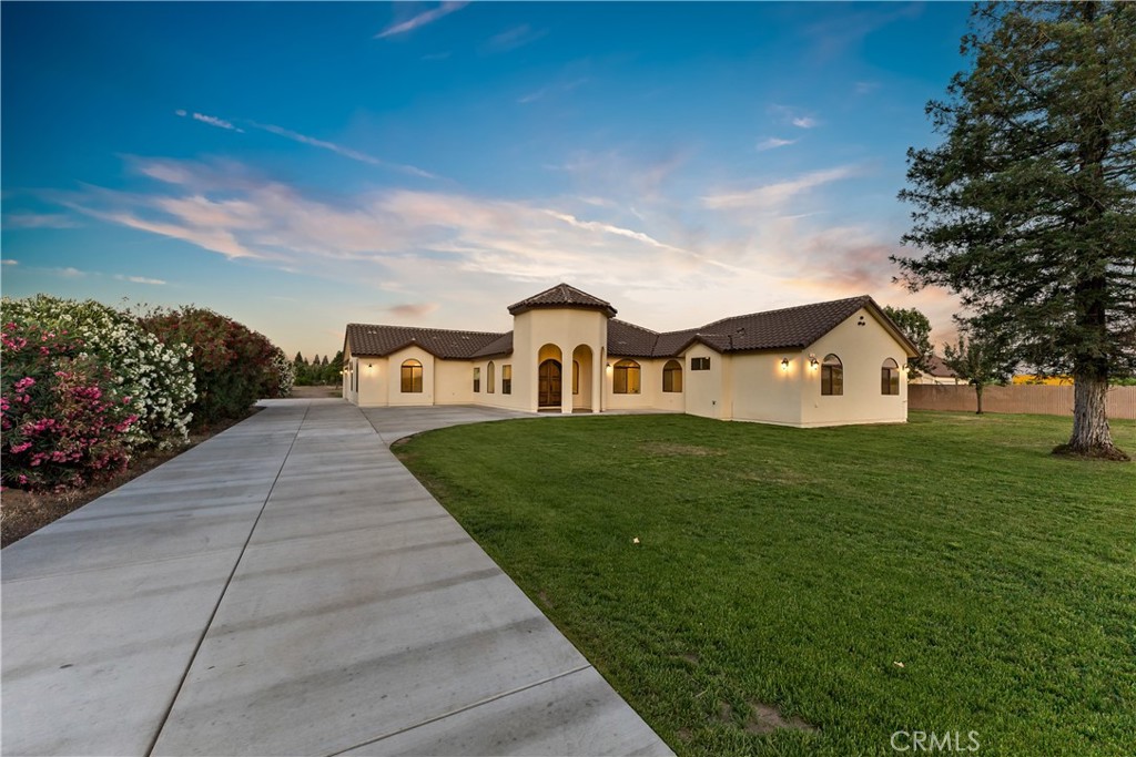Step into your dream lifestyle with this breathtaking 5-bedroom, 4.5-bath custom-built residence. Nestled on over 2 acres of serene land, this stunning property offers the ultimate private oasis for you and your family. From the moment you enter through the exquisite mahogany arched front door, you'll be captivated by the exceptional craftsmanship and attention to detail. Experience spaciousness like never before with soaring 10-foot ceilings and an open-concept layout that seamlessly blends two distinct living areas for both comfort and versatility. The heart of the home boasts beautiful quartz countertops, a large island perfect for gatherings, and brand-new stainless steel appliances. Retreat to the luxurious master bedroom featuring a custom closet and indulge in relaxation with a beautifully designed tub that's perfect for unwinding after a long day. Elegant arched hallways and windows, alongside a smooth textured finish on the drywall, enhance the sophisticated ambiance throughout every corner of this masterpiece. Stay connected and entertained with advanced technology features including data communications wiring, built-in speakers, and two energy-efficient Lennox A/C units. Plus, enjoy ample storage with a large concrete driveway leading to an oversized 2-car garage. The expansive back patio is perfect for hosting friends or simply enjoying peaceful moments in your beautiful surroundings. Don't let this property slip away! Schedule your private showing today!