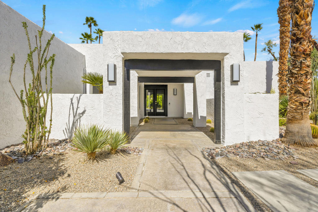 Designed for effortless and sustainable desert living, this recently updated Rancho Mirage home blends elegance, comfort, and privacy on an 11,326 sq/ft corner lot in the very sought-after Tamarisk area. Energy-efficient upgrades include OWNED Solar with a Tesla battery and a 240v EV electric outlet, dual-pane windows and doors, two-zone HVAC with smart thermostats, tankless water heater, whole-house reverse osmosis system, and water softener. The layout emphasizes high ceilings in the living area and primary suite, creating a light-filled, open feel. A three-sided fireplace anchors the main living spaces, while quartz countertops and smooth-coated walls and ceilings bring a modern touch throughout. Both bedrooms are en-suite, while the den provides flexible space for work or an additional sleeping area. Out back, a covered patio, pool, and spa are surrounded by mature landscaping that enhances the sense of seclusion. This large corner lot allows additional leisure space in the front yard shaded by mature Palo Verde and Eucalyptus trees and shielded by a Ficus hedge. A rare 3-car garage with new epoxy floors completes this well-appointed residence. With no HOA or land lease this calm retreat combines convenience, efficiency, and the relaxed lifestyle of Rancho Mirage's Tamarisk neighborhood.
