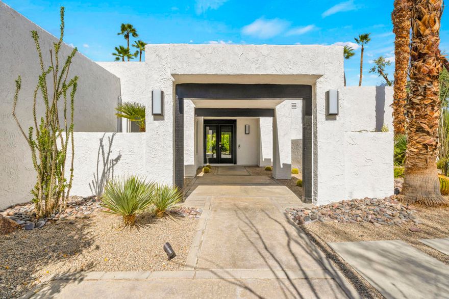 Designed for effortless and sustainable desert living, this recently updated Rancho Mirage home blends elegance, comfort, and privacy on an 11,326 sq/ft corner lot in the very sought-after Tamarisk area. Energy-efficient upgrades include OWNED Solar with a Tesla battery and a 240v EV electric outlet, dual-pane windows and doors, two-zone HVAC with smart thermostats, tankless water heater, whole-house reverse osmosis system, and water softener. The layout emphasizes high ceilings in the living area and primary suite, creating a light-filled, open feel. A three-sided fireplace anchors the main living spaces, while quartz countertops and smooth-coated walls and ceilings bring a modern touch throughout. Both bedrooms are en-suite, while the den provides flexible space for work or an additional sleeping area. Out back, a covered patio, pool, and spa are surrounded by mature landscaping that enhances the sense of seclusion. This large corner lot allows additional leisure space in the front yard shaded by mature Palo Verde and Eucalyptus trees and shielded by a Ficus hedge. A rare 3-car garage with new epoxy floors completes this well-appointed residence. With no HOA or land lease this calm retreat combines convenience, efficiency, and the relaxed lifestyle of Rancho Mirage's Tamarisk neighborhood.