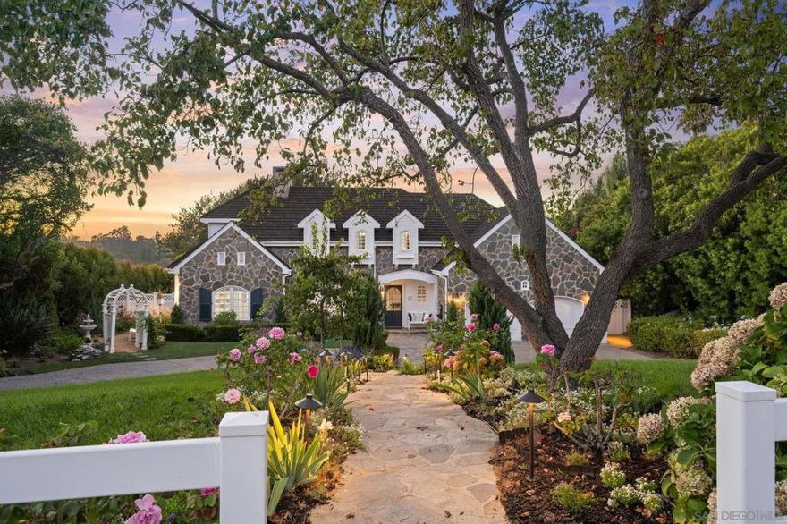 A perfect blend of timeless East Coast charm with relaxed Southern CA Living! The home is set on a generous usable lot with Panoramic Countryside Views & Sunsets, incredible gardens, and grass yard all delivering scale, privacy, and proximity to the Village, golf, beaches, and award-winning schools. The interior and exterior are full of generous "sun kissed" spaces with French doors that frame the entire back wall, inviting year-around indoor/outdoor living. The luxurious primary suite offers lovely vistas, large walk-in custom closet and grand spa bath with lovey views over the gardens. Each room offers total privacy and an incredible setting. The kitchen looks like a page out of Veranda Magazine and is equipped with Thermador, SubZero Refrigerator and Freezer, dual ovens, walk-in pantry, and large center island open to casual dining which flows seamlessly outdoors, where an expansive brick terrace, gardens, and covered loggia with fireplace extend living space year-round. The yard can easily accommodate a detached ADU with separate entrance for guests or family members. This property is so beautiful and unique ~ won't last long!