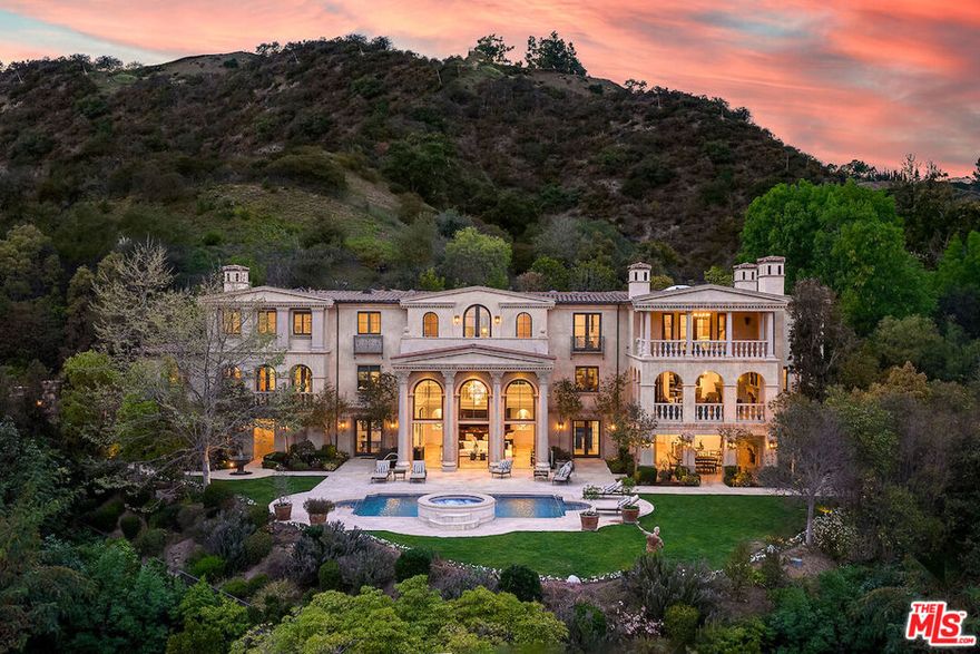 Previously Listed at $23,800,000. Newly reimagined for 2021 with hundreds of thousands in upgrades this Bel Air estate has timeless appeal with a warm, contemporary aesthetic that elevates its existing elegance to a resort at home.   Villa di Ricci, an ultra-exclusive estate nestled in the hills off a semi-private road behind double gates surrounded by dramatic canyon & city light views and just minutes to Sunset Blvd or approximately 20 minutes to both LAX or Van Nuys private airport.  An entertainer's paradise, this estate has an indoor-outdoor resort-style design with multiple terraces, plus 1.5 acres of freshly landscaped grounds creating a tucked sense of privacy that center around a pool with a spa and arcing fountains. Host in the formal living room open to a covered loggia or your choice of a formal dining and wine room; a gourmet kitchen with a breakfast room & service kitchen or linger over drinks in a salon with a restaurant sized bar.  Treat yourself to an in-house spa-styl