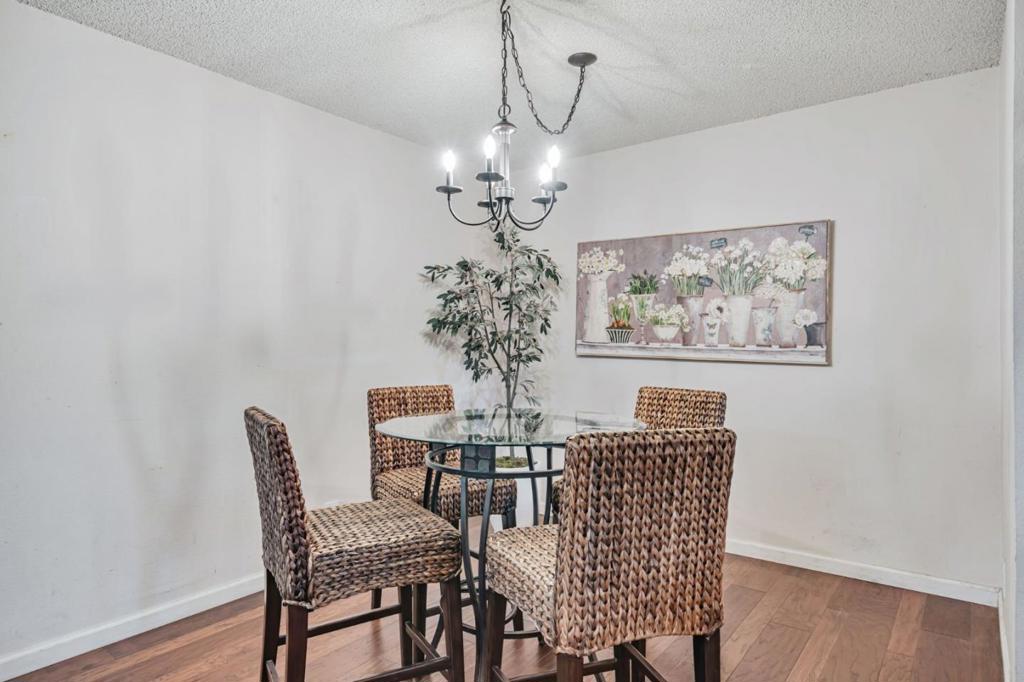 Great downstairs unit Move in Ready..Pride of Ownership. Open and airy. Natural light. Real walnut flooring throughout. 1-1 with an open feeling and a good floor plan.Perfect size bedroom with Walk in Closet. Patio for that nice cup of tea and a good book. Sellers have loved living here. Property has a good feel to it. Great location, close to light rail, shopping, gas stations and plenty of places to eat.