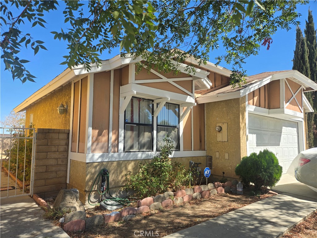 Welcome home to this charming 2-bedroom 2-bathroom Palmdale home! Enter into the open spacious living room with vaulted ceiling, cozy fireplace and sliding door access to the large back yard. Continue into the inviting dining space with a ceiling fan large window and plenty of room for a large dinning set perfect for the holidays and special occasions. Updated kitchen is equipped with stainless steel appliances, a deep stainless-steel sink and ample cabinetry. The laundry area is conveniently located within the home and includes the washer and dryer. The primary bedroom is a vast and tranquil space with a large closet and updated full bath with beautiful quartz countertop vanity and new mirror and light fixture. The second bedroom is also very roomy with a large closet. 2nd full bath also updated with quartz countertop vanity, mirror and light fixture. This home also features new water-resistant wood grain laminate flooring, vertical blinds, updated modern ceiling fans throughout home and central air and heating. Large private backyard with covered patio great for entertaining with block wall fencing. Direct access to the large 2 car garage. Located near parks, freeway, schools, shopping & Dining!