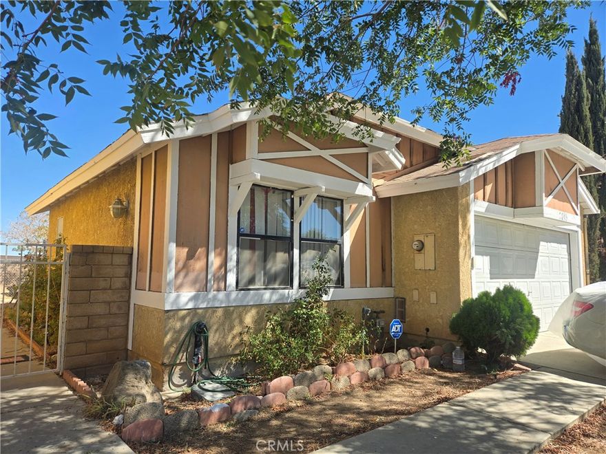 Welcome home to this charming 2-bedroom 2-bathroom Palmdale home! Enter into the open spacious living room with vaulted ceiling, cozy fireplace and sliding door access to the large back yard. Continue into the inviting dining space with a ceiling fan large window and plenty of room for a large dinning set perfect for the holidays and special occasions. Updated kitchen is equipped with stainless steel appliances, a deep stainless-steel sink and ample cabinetry. The laundry area is conveniently located within the home and includes the washer and dryer. The primary bedroom is a vast and tranquil space with a large closet and updated full bath with beautiful quartz countertop vanity and new mirror and light fixture. The second bedroom is also very roomy with a large closet. 2nd full bath also updated with quartz countertop vanity, mirror and light fixture. This home also features new water-resistant wood grain laminate flooring, vertical blinds, updated modern ceiling fans throughout home and central air and heating. Large private backyard with covered patio great for entertaining with block wall fencing. Direct access to the large 2 car garage. Located near parks, freeway, schools, shopping & Dining!