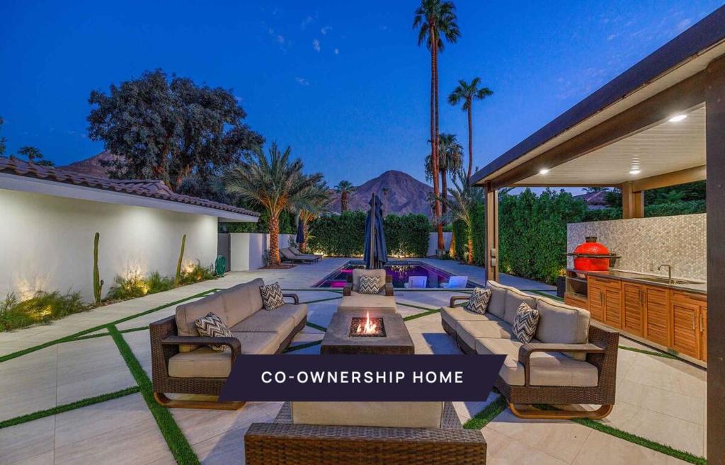 New co-ownership opportunity: Own one-eighth of this turnkey home, professionally managed by Pacaso. With vast spaces inside and out, this 4-bedroom, 4-bath Coachella Valley home is designed for spending quality time with family and friends. The living room sets the home's tone of relaxed sophistication. Contemporary furnishings make it easy to chat or binge watch a favorite show. Sliding glass doors connect to a shaded outdoor seating area. The spacious family room includes a pool table, a fireplace and plenty of couches for gaming or watching TV. The room opens to the gorgeous kitchen with a dramatic waterfall island, wood cabinets and high-end appliances, including a full-size beverage refrigerator. It's easy to grab a snack, serve guests in the elegant dining room or prepare a casual meal on the covered patio. The backyard patio also has loads of comfortable seating surrounding a fire table. A covered outdoor kitchen features a stainless steel gas grill and a ceramic charcoal cooker. This perfect palm-edged oasis offers a large pool and spa, with views of the mountains. The calm and spacious primary suite has a seating area that faces a gas fireplace and TV, and doors that open to the private yard. There's tons of storage in the roomy closet, and the bright en suite bathroom features a long double vanity, a relaxing soaking tub and a tiled shower. This one-level home has a Spanish-style tile roof and mature landscaping.