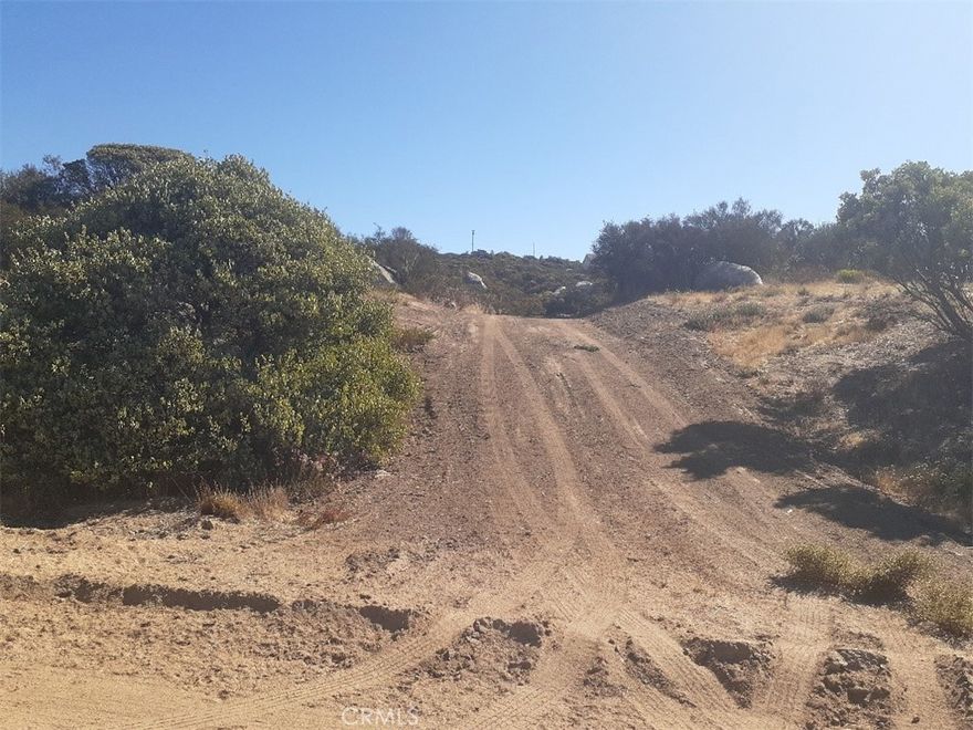This charming parcel of  2.52 ac  entrance is off a private cul da sac ,Rock Valley Way . Some clearing on the lot for easy access. Has panoramic views, and lot line boarders Lake Canyon Rd as well .  Lots of possibilities. Natural vegetation and trees .Enjoy tranquility and fresh air and low property tax. Equestrian based gated community with lake, fishing, private Airstrip, pool, play grounds, BBQ area, basket and volley ball courts, security, gated, roads maintained by association, on volunteer fire department ,  office. Occasional snow, 3400 elevation, low property tax. 3 miles close to Cahuilla Casino and 25 NE of Temecula and 15 Frwy. Owner May Carry