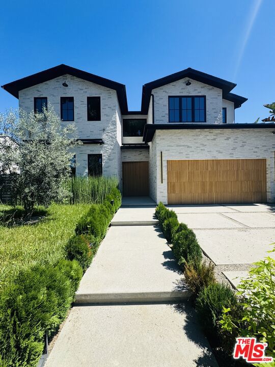 Welcome and be the first to live in this exceptional new construction estate situated in the heart of Sherman Oaks. This gated property offers a 5-bed, 6-bath in the main residence, along with a versatile detached ADU. A charming white brick facade, complemented by organic design elements, sets the tone for a warm and inviting home that effortlessly blends timeless elegance with modern amenities. Inside, enjoy an open-concept layout that features a gourmet chef s kitchen outfitted with top-of-the-line appliances, Taj Mahal quartzite countertops and a large island with a breakfast counter. The adjacent formal dining room is illuminated by a bespoke chandelier, perfect for hosting intimate dinner parties or large gatherings. Highlighted by a hand carved, fluted limestone fireplace, the spacious living room also boasts an oversized sliding glass door that disappears into the wall, seamlessly extending your living space outside. Privacy hedges envelop the property, creating a personal sanctuary that offers a sense of reprieve from the hustle and bustle of the outside world. Designed for both relaxation and entertaining, the backyard features a sparkling pool/spa, outdoor kitchen, lush grassy yard, and ample patio space for al fresco dining. Head upstairs to find a well-appointed laundry room and four generously sized ensuite bedrooms, including a luxurious primary suite that consists of a private balcony with a cozy fireplace, custom walk-in closet, and chic spa-like bathroom, complete with a rainfall shower, soaking tub, and double vanity. The detached ADU is equipped with a kitchenette and full bath, providing endless possibilities - utilize the space as an office, gym or separate living space for family/guests. Additional highlights include a main-level ensuite bedroom, high ceilings, stunning white oak flooring, built-in speakers, and a two-car garage. Located just moments from Westfield Fashion Square, Ventura Boulevard s vibrant shopping and dining scene, and top private schools such as Notre Dame, Harvard-Westlake, and Campbell Hall.