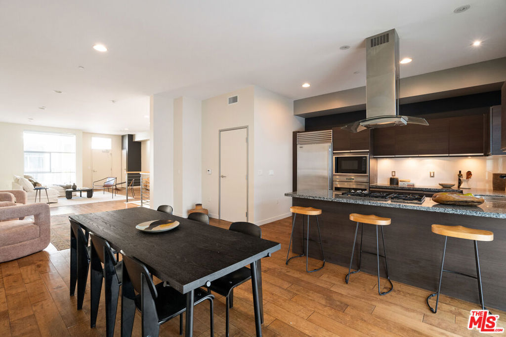 Experience a sophisticated lock-and-leave lifestyle in the heart of Marina del Rey's most sought-after enclave. This stunning two-level townhome in the prestigious Latitude 33 Boardwalk Collection blends modern elegance with coastal sophistication just steps from world-famous beaches and vibrant Westside living. With over 2,000 square feet of thoughtfully designed space, this 3-bedroom, 2.5-bath residence features soaring ceilings, oversized windows, and rich hardwood floors. Located on the top floor, the windows and skylight flood the home with natural light. The open-concept floor plan flows effortlessly into a chef's kitchen equipped with sleek countertops and high-end Viking appliances ideal for casual meals or elegant entertaining. Downstairs, the luxurious primary suite offers a spa-like bath and a generous walk-in closet, while two additional bedrooms and in-unit laundry add everyday convenience. Enjoy resort-style amenities and unmatched convenience, including 24-hour security, concierge service, and a full-service fitness center, all within an impeccably maintained community. Located just moments from Abbot Kinney, Venice Beach, the Marina waterfront, and the best shopping and dining on the Westside, this is modern coastal living at its finest.