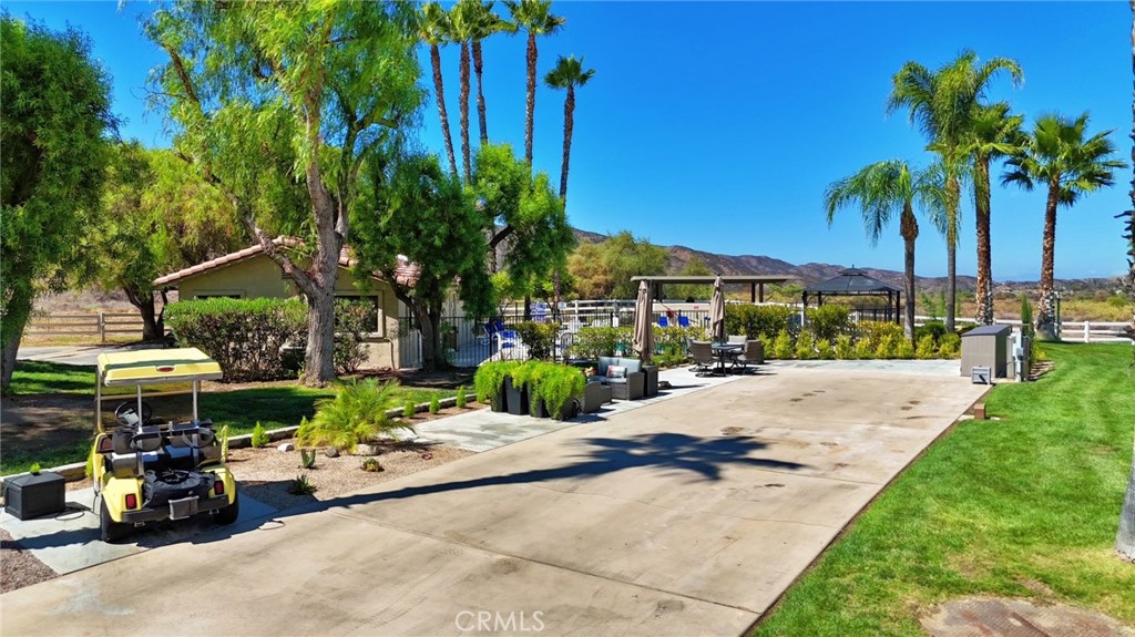 Welcome to your corner RV lot with expansive views of open space and surrounding hillside. This lot is located near pool 5 and main club house. A lighted stone capped column with golf cart parking is a touch of convenience. A crushed granite planter bed and drought tolerant plants adds a clean, fresh look to enjoy. Additional poured concrete creates large seating and entertaining areas. South side of property is lined with a recently planted hedge, landscape rock and stone boarder. Beyond the property line, common area with a large shade tree and grass area provides separation from neighboring RV lots. The resort itself is not age restricted and offers the best in southern California vacation living. Located 45 minutes outside of Palm Desert and with an elevation of almost two thousand feet, provides pleasant temperatures year round. For enjoyment of owners and guests a 14 hole par 3 golf course, 5 pools, spas, fishing lake, market, laundry/shower facilities, dog park, recently remodeled tennis/pickleball courts, horse shoe pit and acres of room to roam.