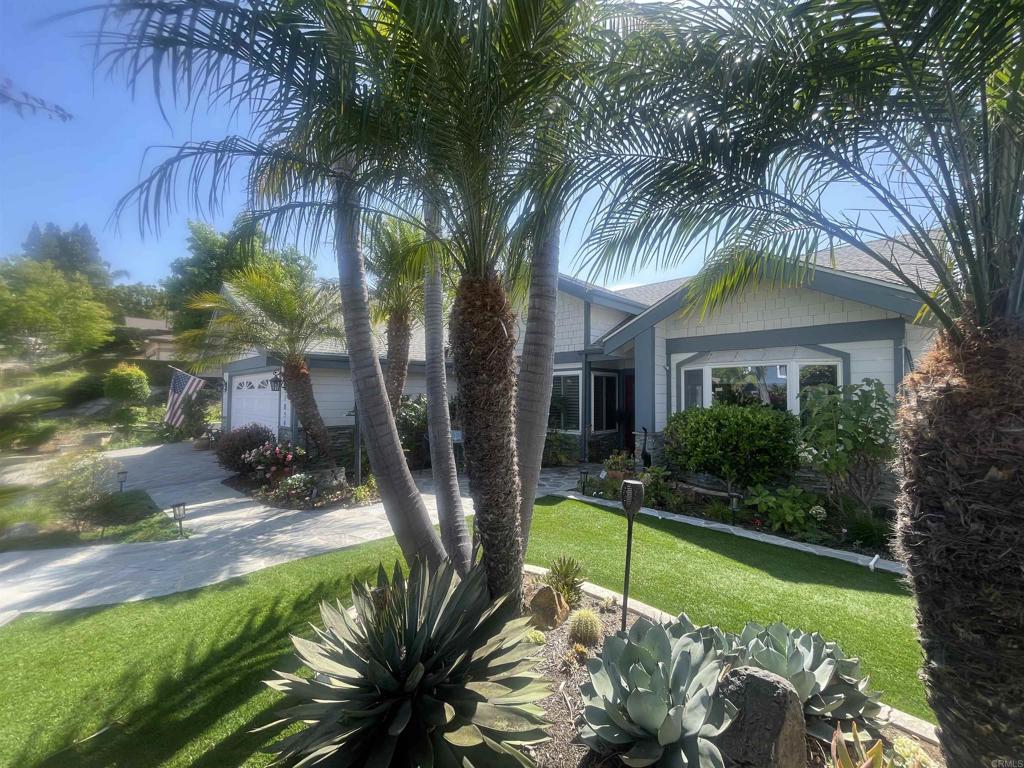 Lake San Marcos luxury views abound in this light and bright, window-lined golf course home on the 14th fairway of the Links at Lakehouse championship course. Soak up the sprawling vista of a blanket of green surrounding a majestic olive tree and peaceful pond just beyond. Enter in to the wide open living room under vaulted ceilings (and under a new roof!), enjoy a gas fireplace and the simple elegance of the upgraded luxury vinyl plank flooring and the natural flow of this well-planned layout. The remodeled kitchen has new cabinets, large gathering island with storage and bar seating, extra-large pantry, dining nook, Bosch dishwasher, new LG refrigerator, wine fridge and raised ceilings. Wander out to the huge wrap-around patio off the kitchen and under the tall, automated patio cover and experience those beloved breezes so coveted by those who live here at the lake. Sunset sits-and-sips out here are dreamy and are just a taste of the joy-filled days you will delight in among all the Lake San Marcos resort activities. Back inside, a large dining room beckons you for meals and memory-making while gazing through the bay window at the lush, yet low maintenance and private, front yard. The primary bedroom is large with a spacious ensuite bathroom, two walk-in closets and a bonus room/office/sunroom adjacent to the primary. A large, 2-car+golf cart garage with wonderful workbench and several tall storage closets lining the walls, plus pull-down attic storage, will woo the hobbyist and win over the future homeowner who loves optimal storage and organization for all their treasures! There is no HOA fee here, despite the resort life you'll be living! You can, however, choose to opt in, for a low annual fee, to the lake & lodge benefits of two pools, pickleball & tennis courts, boat rentals, discounts at the hotel, and more!