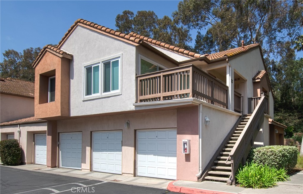 Step into this stylish and upgraded lower-level unit, perfectly situated in a quiet and peaceful area of the community. Featuring elegant wood laminate flooring throughout, granite countertops, plantation shutters, and newer dual-pane windows, this home offers both comfort and modern appeal. The spacious bathroom has been tastefully upgraded, and the entire unit has been completely re-piped for peace of mind. Enjoy the convenience of a walk-in closet, full-size washer and dryer, and a detached one-car garage. Community amenities include a sparkling pool, relaxing spa, and a well-equipped fitness room. Ideally located within walking distance to shopping, restaurants, and a movie theater, and with easy access to the 73 Toll Road and I-5 Freeway, this home combines tranquility with unbeatable convenience.