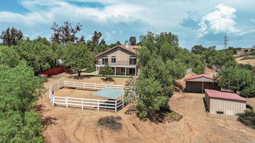 Multi-generational living opportunity at this 5-bed, 4-bath, 4,206 sq. ft. Valley Center home offering multi-generational living at its best on a spacious2.08-acre lot. Designed like two homes in one, the property features two full kitchens, two laundry areas, and separate private entries, making it ideal for a guest house, in-law suite, or income potential. Perfect for a hobby farm lifestyle, the grounds include mature oak trees, two outbuildings, corrals, a chicken coop, and plenty of space for animals or gardening projects. Inside, the upstairs showcases a like-new kitchen, generous living areas, and serene views, while the downstairs offers its own independent living quarters. A three-car garage, quiet cul-de-sac location, and sweeping country vistas complete this unique property. Whether you’re seeking a home for extended family, an income-producing opportunity, or simply room to live your country dream, this versatile retreat has it all.