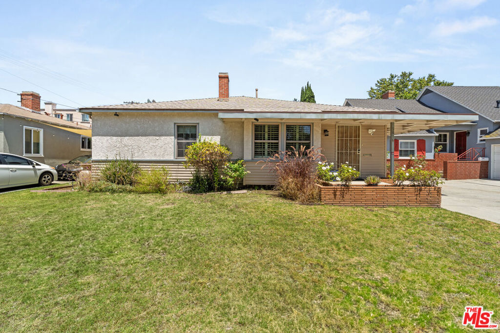Welcome to this 3 bedroom, 2 full bath home on a tree-lined street in Palms with its own private, grassy back yard & Tesla EV CAR CHARGER. This home offers everything a discerning tenant is looking for... location, size, charm and modern conveniences. Located just seconds to both the 10 & 405 freeways for easy access to most of Los Angeles & just a block from Clover Ave Elementary. With almost 2,100 sq ft of living space, the home features a charming living room with wood-beamed ceiling and fireplace and a large galley kitchen with tons of storage giving way to a windowed dining area. All three bedrooms are on one side of the house, including the large primary with its full wall of closets. In the back of the house is an oversized family room/den that opens up to the tree-covered back yard. Home also features a carport with Tesla EV car charger, a 2-car garage, and a full-sized washer/dryer off-kitchen. Pets okay - one dog & one cat max. Landlord pays gardener, Tenant pays all other bills. Available immediately!