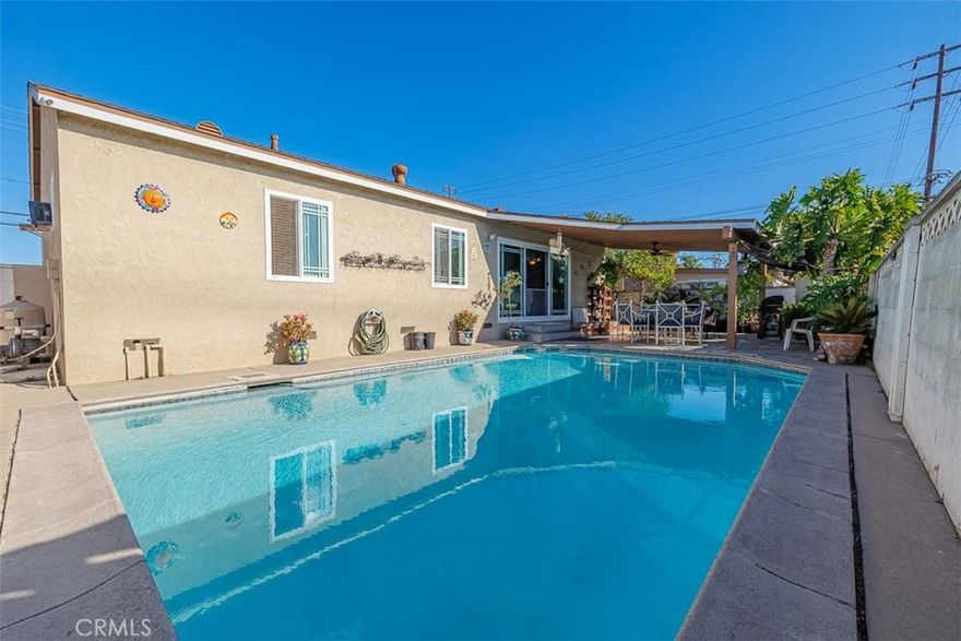 Welcome to 605 N La Reina Street, an incredible single-level pool home situated on a spacious 6,000+ sq. ft. lot in the heart of Anaheim. This rare gem is one of the few properties that backs directly to the tranquil AG Nursery—offering exceptional privacy with no homes behind. From the moment you arrive, you’ll be greeted by beautiful curb appeal, featuring a large grassy front yard and an extended driveway that accommodates up to four cars. Step inside to a warm and inviting living room with serene views of the backyard. The living area seamlessly connects to the dining space—perfect for entertaining family and friends during the holidays. The chef-inspired kitchen boasts stainless steel appliances, a built-in 5-burner gas range, double oven, and ample storage throughout. A cozy breakfast nook sits between two pantries for added convenience, and direct garage access makes daily living effortless. Flow easily through the thoughtfully designed single-level floor plan to the private living quarters, where you’ll find three generously sized bedrooms. The primary suite includes an en suite bathroom with a walk-in shower, while a full hall bath with a shower/tub combo serves the secondary bedrooms. Dual-pane sliding glass doors open to an entertainer’s dream backyard—complete with a sparkling pool, covered patio with ceiling fan, outdoor storage shed, and multiple fruit trees. This home offers unbeatable convenience, with easy access to the 5 and 91 freeways, Beach Blvd, nearby restaurants, shops, and grocery stores. Enjoy proximity to Dad Miller Golf Course (less than a mile away), Savanna High School, Peter Marshall Park, Knott’s Berry Farm, and Disneyland—all just minutes from your door. Don’t miss this amazing opportunity to own a true Anaheim gem. Schedule your private showing today!