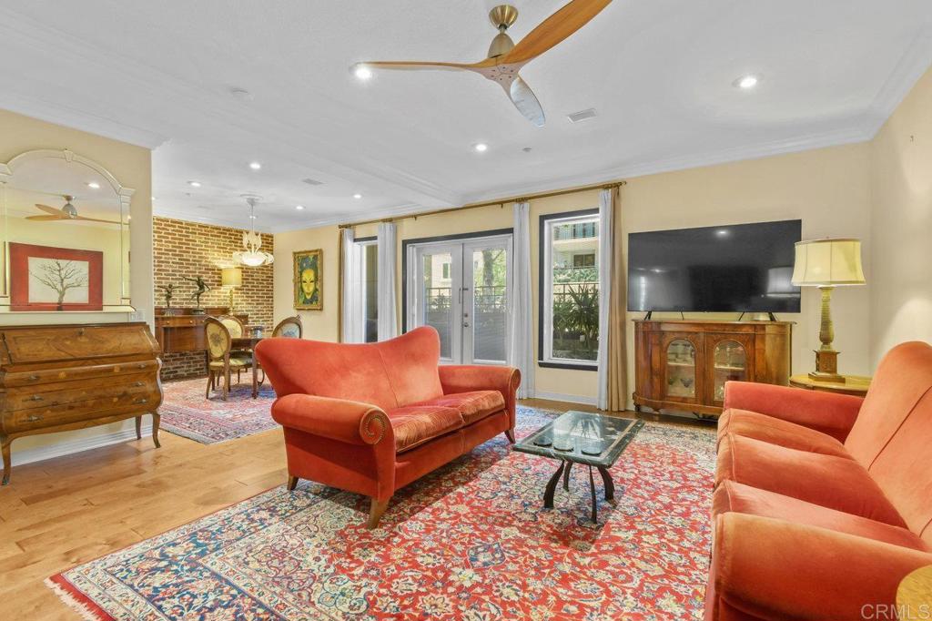VA approved Expansive townhome in the heart of the Marina District at City Walk. This tastefully upgraded 2-bedroom, 2.5-bath residence offers one of the largest floor plans in the complex and area, with 1,922 square feet of living space. Interior features include birch wide-plank distressed wood floors, crown molding, high ceilings, and arched doorways. A gourmet kitchen with granite countertops, stainless steel appliances, breakfast bar, wine chiller, and a brick accent wall and backsplash. A balcony off the main living and dining area—with newly installed French screens—offers pleasant neighborhood views. Upstairs are two spacious primary suites, each with granite counters, dual sinks, and mosaic tile flooring in the bathrooms. The second level also includes a private balcony off the primary suites. Additional highlights include fresh interior paint, elegant Italian Thassos and Carrara marble accents, 2 parking spots side by side, and 4 deep locked storage closets on the balconies. Situated in the Marina District, you’re just steps from the marina, parks, restaurants, shops, grocery stores, Petco Park, Seaport Village, Little Italy, and only a block from the dog park. Community amenities include two formal building entrances, three beautifully landscaped atriums with seating and firepits, a gym, bike storage, and weekday on-site management.