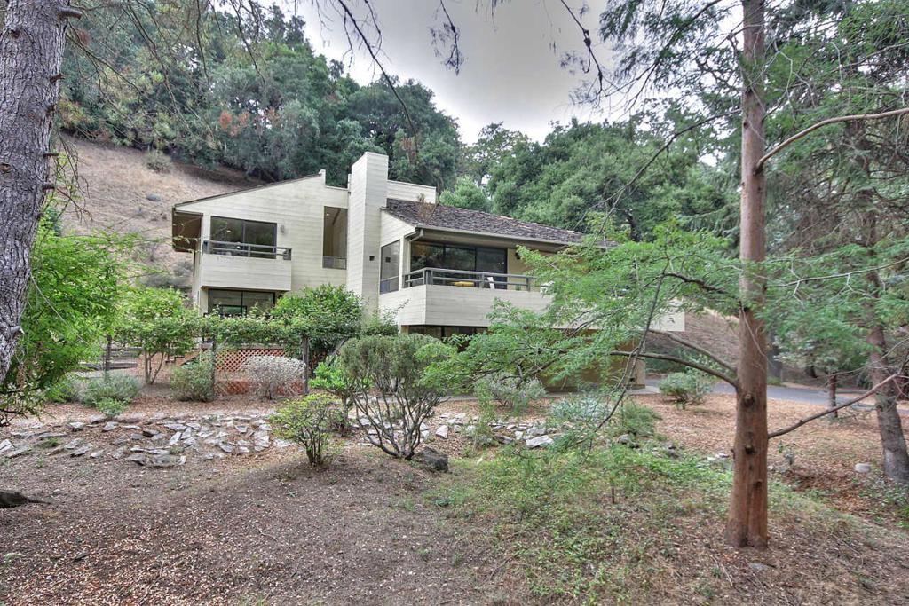 First time on market in 18 year! Tucked away in a wooded area of Los Altos Hills, this multi-level contemporary home offers the charm of a rural retreat with the convenience of city living. The 4 bedroom, 3 bath home has an inviting open living area with high ceilings. Conveniently located within easy access to 280, steps away from a local hiking trail & minutes away from downtown Los Altos. Neighborhood schools include Loyola Elementary, Blach Middle and Mountain View High (buyer to verify).
