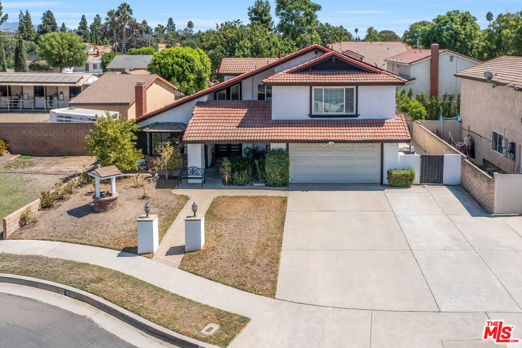 Tucked away on a quiet cul-de-sac, this beautifully remodeled 4-bedroom, 3-bathroom home combines modern elegance with everyday comfort. Step inside to find stunning laminate wood floors, soaring ceilings, and expansive windows that flood the space with natural light. The attached two-car garage has been upgraded with a custom-built gym or versatile storage area, adding functionality to the home. The chef's kitchen is an entertainer's dream, featuring a double oven, gas cooktop, French-door refrigerator, brand-new cabinetry, Carrera countertops, and a picture window with views of the backyard oasis. The inviting primary suite boasts sweeping mountain views, a generous walk-in closet, and a spa-like bathroom with dual sinks. Step outside to enjoy a heated pool and spa, fire pit, and beautifully landscaped grounds perfect for gatherings or quiet evenings under the stars. Additional highlights include central A/C and heat, recessed lighting, ceiling fans, and RV parking.