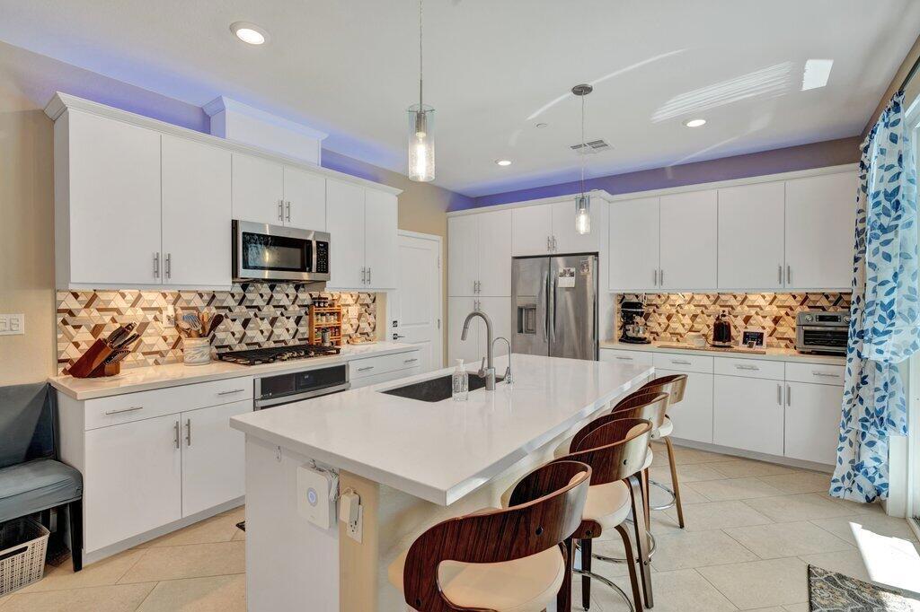 You will love living in a newer townhome in University Park in Palm Desert. This home has so many wonderful features! There is a solar system with batteries that is owned by the landlord. Last year, his total bill for electricity was $200. This is a 3 bedroom, 2.5 bath townhome with an attached garage with a EV charger (220V) for electric cars in the garage. You have direct access to the home from the garage, coming into the kitchen. You'll love the kitchen, it's really a chef's dream kitchen with a gas range and self-cleaning oven. The washer, dryer and refrigerator are included in the rent. Beautiful tile and carpet in just the right places. There is a beautiful backyard with a propane BBQ, fruit trees and a raise garden/vegetable area for a beautiful garden. The community has a salt water pool and spa area with restrooms, a BBQ area, firepit and kitchenette. You can rent out the pool area for special events for a small fee from the HOA. There's a park nearby and a dog park. Great location in PD and close to the 10 Freeway. Come take a look at this fabulous home. Available Nov. 1, 2025, must be a one year lease.
