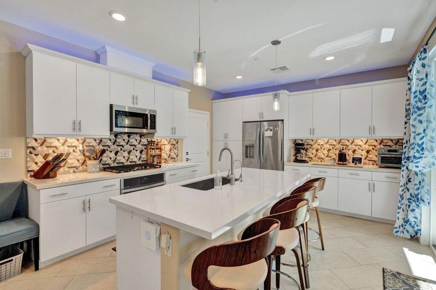 You will love living in a newer townhome in University Park in Palm Desert.  This home has so many wonderful features!  There is a solar system with batteries that is owned by the landlord.  Last year, his total bill for electricity was $200.  This is a 3 bedroom, 2.5 bath townhome with an attached garage with a EV charger (220V) for electric cars in the garage.   You have direct access to the home from the garage, coming into the kitchen.  You'll love the kitchen, it's really a chef's dream kitchen with a gas range and self-cleaning oven.   The washer, dryer and refrigerator are included in the rent.   Beautiful tile and carpet in just the right places. There is a beautiful backyard with a propane BBQ, fruit trees and a raise garden/vegetable area for a beautiful garden. The community has a salt water pool and spa area with restrooms, a BBQ area, firepit and kitchenette.  You can rent out the pool area for special events for a small fee from the HOA.  There's a park nearby and a dog park.  Great location in PD and close to the 10 Freeway.  Come take a look at this fabulous home.  Available Nov. 1, 2025, must be a one year lease.