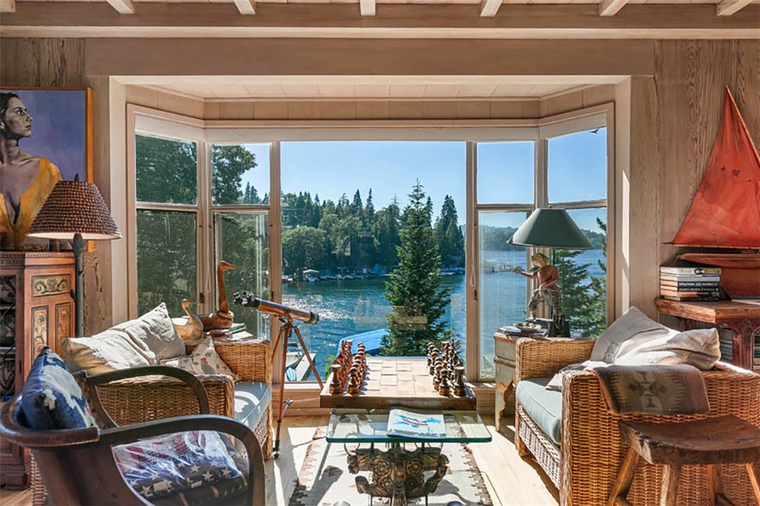 The Cottage. A rare find among Lakefronts, Indeed! It is not often a classic Lakefront Charmer becomes available for sale. This glorious Lodge has been lovingly cared for by the Owners for over 30 years. It is their “Jewel” and one of a kind. Restored to perfection and offered Furnished, with a DOUBLE CANOPIED DOCK in "deep water" of prestigious Emerald Bay, and SEPARATE GUEST HOUSE with Living Room, Kitchen and Bedroom. The Lush Green Compound is an "estimated" 3,500 sq. ft. per Sellers and situated within a magical setting of Tall Trees, meandering Ponds and trickling Waterfalls filled with Koi fish. A large "flat" grass recreational space is perfect to watch the exquisite afternoon sunsets! The Lake Views are spectacular from all points! The Lodge is cozy and comfortable, just like you see in the movies. It is intimate and laid back, with High End Appointments with a Designer Flair. There are hardwood floors, strengthful ceilings and walls with nooks and crannies everywhere! There are Entertaining Terraces and 5 Patios with many timed, LED lights for night time lighting the gently winding Stone Pathways to the Water's Edge and Beach. The landscaping is beautiful with many colorful floral displays in the Spring and Summer. There is a life time tile roof that duplicates wood shake, a Convenience Tram and 2 Car Garage. Extremely modest from the street, there awaits another world to experience! This is the Perfect, Private Lakefront Retreat for those who will only accept the Exceptional!! 1 ½ hours drive from the Desert, the Beach or Beverly Hills.