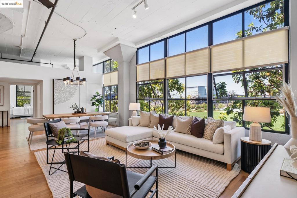 Rare, Coveted, Extra Large - Spacious & Chic 2BR/2BA corner loft in Emeryville’s historic Warehouse Loft building, offering approx. 1,853 SF of flexible space. This light-filled home features soaring extra high ceilings, walls of oversized windows, exposed concrete columns, and an open living/dining/kitchen layout ideal for entertaining or creative use. Fresh & airy with updated kitchen, big rooms, in-unit laundry hookups, and abundant storage — including a rare attic lofty space. The building offers secure entry, elevator, dramatic courtyard with waterfall feature, and rooftop deck with city views. Plus this unit has 2 dedicated parking spaces! Outstanding location: Walk Score 77, Bike Score 91, moments to Bay Street, Public Market, Arizmendi, Pinnacle Badminton, Parks, shops & food, the Emeryville Marina and more. Free Emery Go-Round shuttle to MacArthur BART plus quick freeway access to SF and the East Bay. Architectural Industrial chic meets modern convenience in this move-in ready corner loft. (Note: Common Area photos are from archive- roof deck is not currently furnished! )