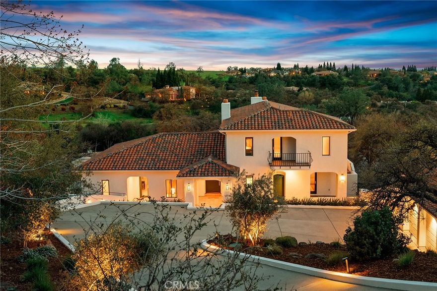 Breathtaking custom home in Canyon Oaks Country Club with unparalleled views! Perched atop a hill, this incredible home offers sweeping views of the golf course, the Coastal Range, and twinkling city lights. Thoughtfully designed for privacy and serenity, the property is surrounded by stunning landscapes, including fruitless olive trees from Sonoma and majestic blue oaks. Step inside through the grand foyer and immediately feel the warmth of this inviting home, where exquisite craftsmanship and designer touches abound. Flooded with natural light, the interior boasts lime-washed, wood-beamed ceilings, elegant arched doorways, and custom chandeliers from South Africa. The living room is the heart of the home, featuring a gas fireplace and a stunning cedarwood Moroccan media cabinet. Designed for both entertaining and everyday comfort, the dining room and breakfast room open to patios, creating the perfect setting for morning coffee or sunset gatherings with breathtaking views. The kitchen is fully equipped with all-new high-end appliances, including a 48” Sub-Zero refrigerator, Wolf double oven, gas cooktop, and microwave. Downstairs, two spacious guest rooms and a guest bathroom with a walk-in shower offer comfort and privacy, along with a private entrance—perfect for hosting guests. Upstairs you will find the primary suite. This is a true retreat, offering a private terrace with panoramic views, a cozy fireplace, a jetted soaking tub, walk-in shower, an expansive walk-through closet, and a library room for quiet relaxation. Outside, the beauty continues with a Bob Hill-designed pool featuring Moroccan tile, a covered patio with a fireplace, designed for year-round enjoyment and entertaining and meticulously planned landscaping surrounding the property. This home is truly one of a kind, blending luxury, comfort, and stunning design. A dream for entertaining, every detail has been thoughtfully curated to create an exceptional living experience. There are too many incredible features to list—you must see this home in person to fully appreciate its beauty and craftsmanship.