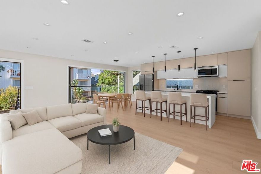 Experience luxury coastal living in this newly renovated 3-bed, 2-bath, top floor unit on the quiet Paloma Ave walk street - just seconds from Venice Beach. This architecturally crafted home combines high-end design, functionality, and smart-home technology. Enjoy open-concept living with floor-to-ceiling windows and a 14-ft folding glass wall that connects the living space to a private balcony - perfect for indoor/outdoor dining while enjoying the ocean breeze. The chef's kitchen features Calcutta waterfall countertops, European cabinetry, stainless Samsung appliances, and a wine fridge. The primary suite includes dual closets, a Juliet balcony, and a spa-inspired bath with Italian marble, rainfall shower, and built in Alexa-operated speaker system. Unwind on the 400 sq. ft. shared rooftop deck with lounge seating, fire pit, and BBQ. Smart-home features include voice/app-controlled lighting, NEST thermostat for central heat and AC, Ring video doorbell, and keypad entry. Tucked on a quiet walk street just steps from Abbot Kinney, Rose Ave, and the Venice Boardwalk, this penthouse delivers privacy, sophistication, and pure California beach living. The unit also comes with two tandem parking spots - one in the garage and one parked behind.