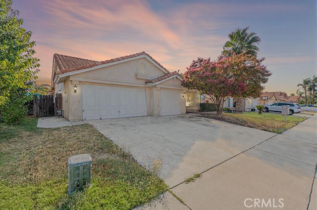 Single-story home located in Hemet with a three-car garage and a spacious backyard that includes a covered patio. Property record shows 4 bedrooms, but was converted to a primary suite den, which can be converted back to a 4th bedroom if owner desired. The interior features carpet throughout, ceiling fans, and a living room with a fireplace. The floor plan offers both a separate living room and a dining nook off the kitchen. The primary suite includes a bathroom with a separate tub and shower. Additional features include multiple secondary bedrooms, ample natural light, and a functional layout designed for comfortable living.
