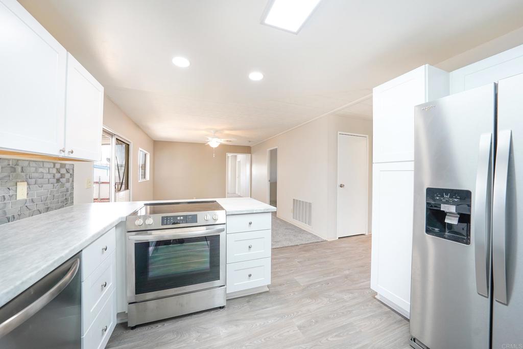 Welcome to this beautifully remodeled manufactured home in the 55+ park of Ramona Terrace Estates! The home remodel includes: New kitchen cabinets, new counters, backsplash, SS appliances, carpeting, paint, Primary bathroom, AC unit and more! This open home is light, bright and spacious! You are located on a corner lot and the home offers covered carport parking and a small fenced area on the side. Turn-key and move in ready!!!