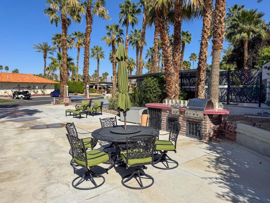 This beautifully northeast-facing lot offers the ideal blend of morning sun and cool afternoon shade--perfect for relaxing outdoors in comfort. Just steps from the nearby satellite pool and laundry facility, this prime location combines convenience with privacy. The spacious layout easily accommodates a 45′ Class A coach and two full-size vehicles. Enjoy outdoor entertaining with a well-equipped kitchen that includes a built-in sink, BBQ, and sear top. The lot also comes furnished with stylish patio furniture and a handy storage deck box. As an owner at Outdoor Resort Indio, you'll have full access to world-class amenities, including golf, pickleball, fitness center, clubhouse events, and more--making this an exceptional opportunity to own in one of the premier motorcoach resorts in the country.‍‍