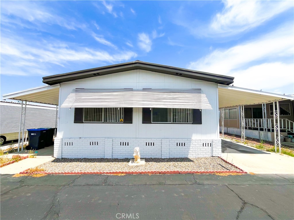 Welcome to this beautifully updated mobile home with a Bonus Room within the ALL AGE Vista de Oro mobile home community. Step inside and notice the vinyl plank flooring that flows throughout the open living spaces and the rest of the interior, providing a sleek and contemporary foundation for your decor. The home features white cabinetry and quartz countertops in both the kitchens and bathrooms, adding a touch of elegance and creating a fresh and airy atmosphere. You'll also find the kitchen equipped with a dreamy large island with ample space for all your cooking and baking needs. Gold accents are also found throughout the hardware, bathroom sinks, and faucets. The freshly painted walls in a neutral white palette create a bright ambiance that complements the natural light. The brightly painted exterior gives the home a polished and inviting curb appeal. Walk out through the sliding glass doors and you'll encounter the side porch that leads to the storage shed in the back. The central air conditioner and ceiling fans throughout the house will keep you cool during summer. Don't miss the opportunity to make this beautiful mobile home your own.
