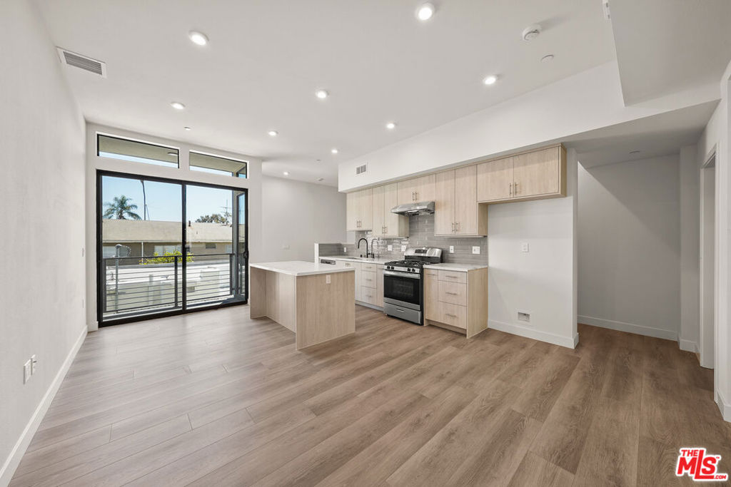 Ready to Lease. First showing available showing on Sunday 1-4 pm. Stylish and ideally situated just behind the front unit, this 3-bedroom, 3-bathroom residence blends modern design with everyday functionality across 1,704 square feet. The entry level features a spacious two-car garage with direct access, along with a private foyer that leads upstairs. The second floor unveils an open-concept living space designed for both comfort and entertaining. A sleek, modern kitchen anchors the layout, custom cabinetry, and a large island ideal for gatherings. Soaring ceilings and a tall wall of windows flood the space with natural light, enhancing the home's bright and airy feel. This level also includes a full bathroom and a flexible bedroom perfect for guests, a home office, or creative space. Upstairs, the primary suite offers a serene retreat with a generous walk-in closet and en-suite bath. An additional bedroom on this floor also features its own walk-in closet and is served by a full bathroom just steps away. A conveniently located in-unit laundry closet completes this level. Crowning the home is a private rooftop patio perfect for al fresco dining, lounging, or enjoying sunset views and glimpses of the Hollywood Sign. Set in one of L.A.'s most iconic neighborhoods, this residence places you moments from the best of West Hollywood, including Melrose Avenue, Santa Monica Boulevard, and hotspots like Catch, Craig's, and the Design District. 1200 1/2 offers sophisticated living with the vibrant WeHo lifestyle right at your doorstep