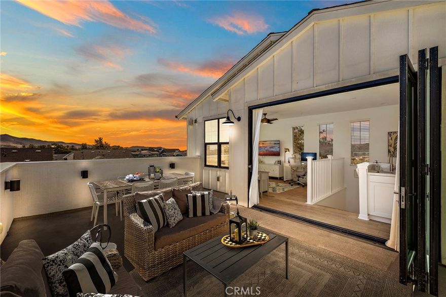 100 Vasto Street – Model Perfection, Elevated Beyond Compare! There’s something magical about model homes, and this former Robert Hidey Architects Canopy 3X model captures that spirit beautifully. Perfectly set at the end of a quiet street near the top of the hill, this modern farmhouse radiates warmth, light, and effortless indoor-outdoor living, all just steps from Rancho Mission Viejo’s premier amenities. Reimagined in 2022 with over $100K in thoughtful, high-end upgrades, including fresh Benjamin Moore paint throughout (ceilings included), high-end porcelain counters with extended island and full backsplash, custom bar with wine rack, designer fixtures, and garage recreation studio with recessed lighting, floating floors, cabinetry, Monster Racks hidden behind beautiful curtains, and dual EV charging. The entry flex room features custom iron and glass doors and a pocket door creating private en suite bath access. The chef’s kitchen shines with GE professional appliances, a Kohler Ripple Farm sink, and crisp white cabinetry opening to lush landscaping, Fire Magic BBQ, and bi-fold serving windows for seamless entertaining. Set within Rancho Mission Viejo, where resort-style pools, fitness centers, farms, and trails create a true sense of community. Life here feels like a daily retreat. Welcome home!