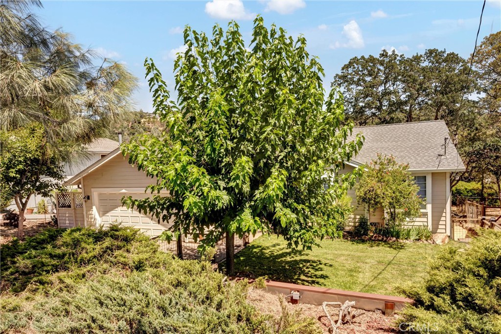 Live the Good Life in Hidden Valley Lake! This stylish, private & turn-key 3BD/2BA home is perfectly positioned just a 5-minute stroll from the community beach, dog beach, and fishing pier—making every day feel like a vacation. Tucked down from the street and hidden behind the lush & mature foliage, discover a beautifully landscaped front yard complete with a lawn & dog-friendly fencing. Step inside to vaulted ceilings, luxury vinyl plank flooring, and upgraded fixtures & ceiling fans. The big picture windows create a bright & welcoming atmosphere. The formal dining room opens to the back deck—perfect for al fresco meals—while the spacious kitchen boasts stainless steel appliances, abundant cabinetry, a breakfast bar, and a cozy dining nook with its own slider to the fenced side yard—ideal for pets or a small garden. Down the hall, find three comfortable bedrooms, all with plush carpet and modern lighting. The primary suite offers vaulted ceilings, a private balcony, and a hotel-inspired bath with dual sinks, a large walk-in closet, and a stall shower with dual shower heads. Enjoy peaceful afternoons on the back deck overlooking the low-maintenance backyard framed by graceful oaks and natural views. Located in the desirable, gated Hidden Valley Lake community, you’ll have access to the private lake, golf course, swimming pool, parks, tennis & pickleball courts, stables, and more—all from a home that blends comfort, style, and an unbeatable location. Home & pest inspections already completed for buyers and this house is ready to go!