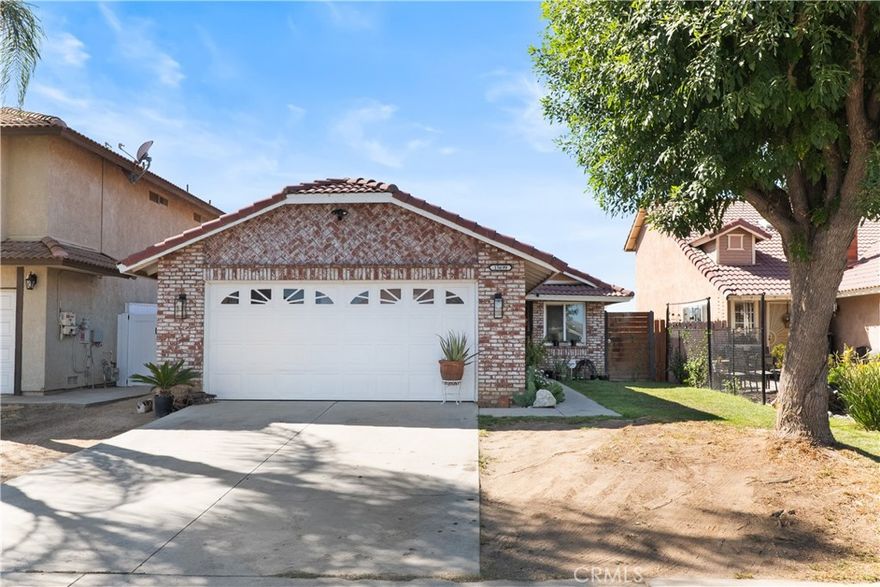 Tucked away in a quiet Moreno Valley neighborhood, this well-maintained 2-bed/2-bath home offers comfort and functionality. Step inside, and you'll find tile flooring throughout the living and dining room areas—perfect for easy cleaning and everyday durability. Both bedrooms feature newer flooring that not only looks clean and modern, but also helps keep the home cooler alongside the central A/C—ideal for those hot California summers. The primary suite includes its own en-suite bathroom for added privacy and convenience. Outside, there is a spacious backyard complete with mature lemon trees, orange trees, and peach trees—a great spot for relaxing or enjoying homegrown fruit all season long.