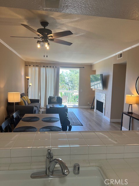This fully furnished 2-bedroom, 2-bathroom unit offers prime living in a prestigious gated community with 24-hour security in Huntington Beach. Enjoy peekaboo pool views from your private balcony and luxury vinyl wood flooring throughout the unit. The kitchen boasts a large breakfast bar, while the living room features a fireplace and sliding glass door, seamlessly merging indoor and outdoor living. The spacious primary bedroom includes a remodeled ensuite bath and another balcony. Community amenities include 4 pools, spas, clubhouse, tennis court, and dog park. Two assigned parking spots in the subterranean garage are included, with additional guest parking available. HOA covers water, trash, and sewer. Ideal for a 5-month furnished lease. Close to beach, shopping, and dining.