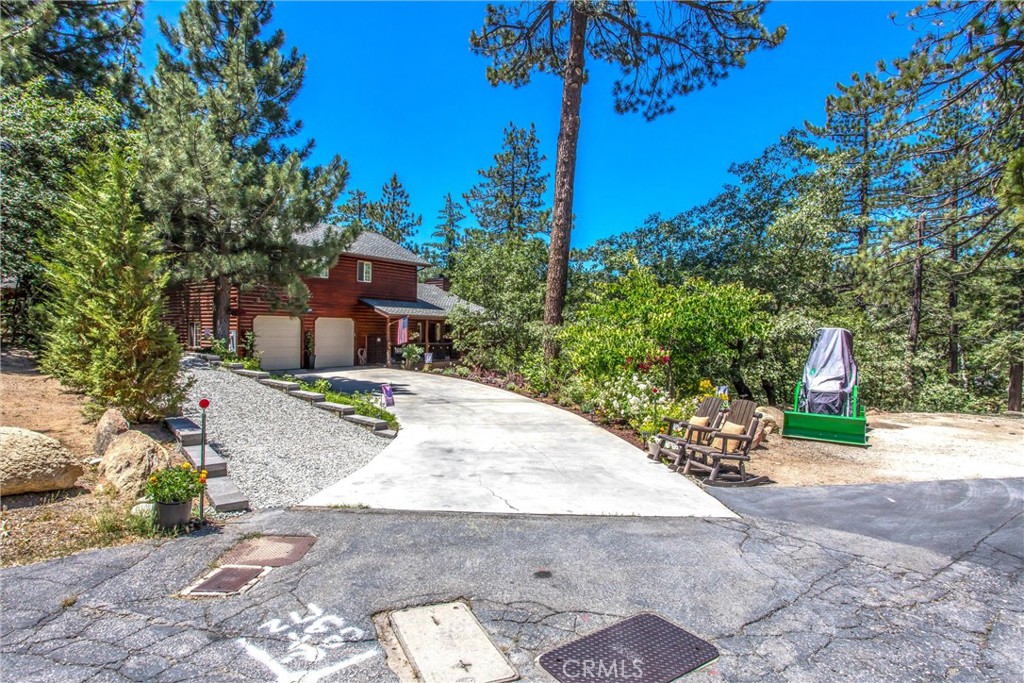 Located in the HIGHLY DESIRABLE, PRIVATE COMMUNITY known as RIMWOOD RANCH! This log sided home nestled on a ONE ACRE forest setting, at the end of a CUL DE SAC. With level driveway and extra parking pad for multiple cars, it has a two car garage attached. As you enter into the home you will love the open concept, light & bright with an upgraded fireplace in family room and a larger deck which is great for outdoor living. The ceiling in tongue and grove knotty pine with a new ceiling fan. The home has been completely upgraded, the kitchen has newer appliances, cabinets, quartz counter tops with an island & recessed lights, all of the bathrooms are freshly remodeled. The home has all new flooring & interior paint. You'll love the bonus living area down stairs with attached screened deck. The aesthetic of the barn area matches the home and is recently built, with extra storage. This is zoned for Horse Property also. There is a newer concrete sundeck patio with lighting & there are so many sitting areas, it is so peaceful & relaxing! There is also EV charging station and transfer switch for the whole house generator. This home is ready to move in & you will not be disappointed, it is a DREAM!!