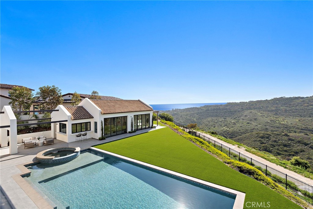 Introducing a rare gem in the esteemed Crystal Cove community, 7 Spinnaker is situated on an oversized nearly 30,000 square foot front-row lot, epitomizing upscale living with its calming ocean and canyon vistas and sophisticated design and privacy, spanning 7,449 +/- square feet (including a brand-new additional dwelling unit of 1,200 square feet).