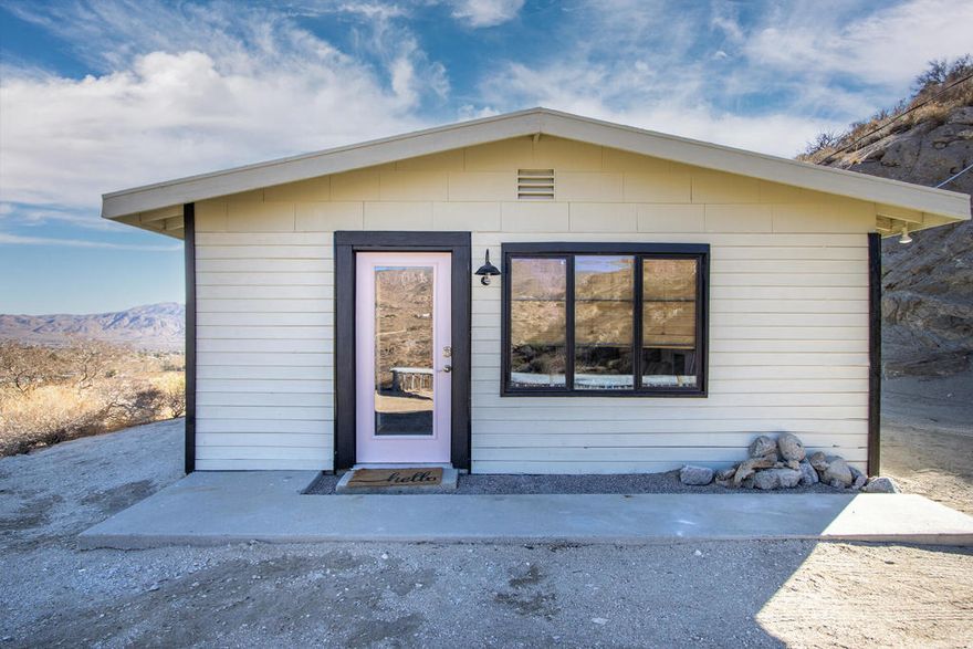 Owner Will Carry Financing! Dream cabin elevated on a hill in the clouds. Meticulously remodeled designer mid century home. Stunning natural panoramic views. 10 acres on two legal lots. Property backs up to government land that connects to the Sand to Snow Monument. Your own nature park with trails, valleys, ridges, and 360' views. Slab walkway leads to the entryway with a matte black barn light. Front door opens to the living room with a masonry fireplace, hearth ledge, gallery wall with picture light and large windows. Kitchen area with recessed lighting, butcher block island, and vintage kitchen. Bedroom nook with inspiring vistas, shelving, ceiling fan, and  breakfast bar table. Bathroom with floating pedestal sink, mirror cupboards, large walk in tile shower. Step out on the hilltop patio high above the valley. Vintage remodeled 50's trailer guest unit with deck patio and sofa chair loungers. Queen bed with cabinets and amazing views. Natural desert fauna of yucca trees, creosote bushes, and cactus. 20 miles to Palm Springs. 115 miles to LA. 21 miles to Joshua Tree National Monument. 10 miles to Yucca Valley. The local Covington Park offers tennis courts, kids playgrounds, and community center. Restaurants and amenities nearby. May qualify for Conventional Lending. Don't wait, Call Now!