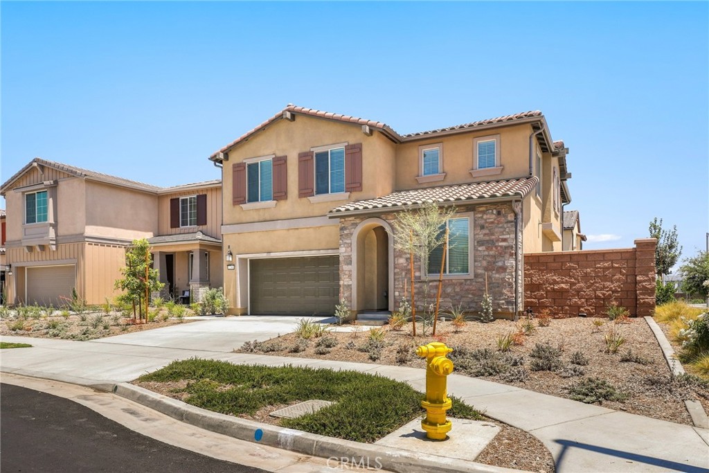 Welcome to 2288 Panama Dr. and discover contemporary elegance in this newly constructed Taylor Morrison home (2025), located in the desirable Harper enclave within the master-planned Bedford community in Corona, CA. Positioned on a premium corner lot, this expansive Plan 3 layout offers over 2,800 sq ft of thoughtfully designed living space, perfect for entertaining, everyday comfort, and extended guest stays. From the moment you arrive, you’ll appreciate the West-facing orientation that fills the home with natural light, leased solar panels, a full-length driveway, and tasteful curb appeal. Step inside to soaring high ceilings, elegant luxury vinyl flooring, and a welcoming first-floor junior suite—an ideal setup for visiting family or long-term guests. The heart of the home is the bright and airy open-concept great room, featuring a chef-inspired kitchen with a large island, walk-in pantry, and generous cabinetry that flows into the dining area and family room. Oversized sliding doors lead to the backyard, blending indoor and outdoor living. Upstairs, a versatile loft offers endless potential as a home office, media room, or play space. The primary suite serves as a private retreat, highlighted by a spa-like bath with a walk-in shower, dual sinks, vanity nook, and a spacious walk-in closet. Three additional bedrooms and a large laundry room with extra storage complete the upper level. An additional lighting package upgrade was incorporated to all bedrooms and loft, adding recessed lighting, J-boxes for ceiling fans and corresponding light switches (~$4k upgrade). The low maintenance rear hardscaping was also just completed to maximize space for entertaining and usage. Residents of Harper at Bedford enjoy a lifestyle surrounded by nature and convenience. With community pools, playgrounds, walking trails, and an upcoming retail center connected by private pathways, Bedford offers something for everyone.