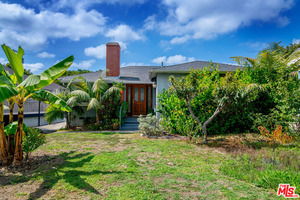 Tucked into a central West LA neighborhood, this home offers the perfect canvas for its next chapter. Whether you envision a thoughtful remodel or a brand-new build, the property delivers excellent potential. The home features an open living and dining area with wood floors, a brick fireplace, and natural light. The kitchen provides ample counter space and storage, ready to be reimagined for modern living. Outdoors, a lush vibrant garden has been cultivated that feels like a private orchard. Among the highlights are four thriving banana trees, a Fuji apple tree, lime tree, grapevine, coffee plant, and chilis. The backyard offers both shaded areas for relaxation and sunny patches for further planting or play. Located just minutes from major Westside amenities, including the upcoming UCLA Research Park. The combination of a prime location, a generous lot, and the opportunity to customize makes this property a smart investment.