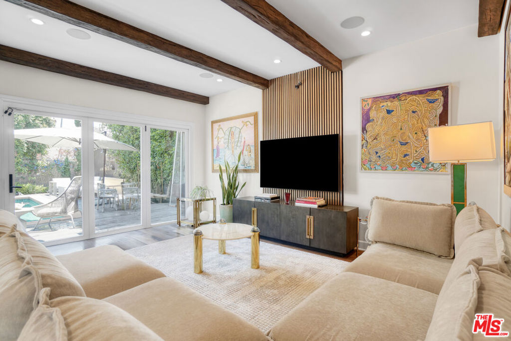 Stunning Spanish Contemporary Home for Lease in Prime Miracle Mile Location. Welcome to this beautifully updated Spanish Contemporary home nestled in a quiet, family-friendly neighborhood in the heart of Miracle Mile. Just steps away from the Petersen Automotive Museum, LACMA, Grammy Museum, and a short 5-minute drive to The Grove and some of the best restaurants in Los Angeles. Only 10 minutes from Beverly Hills and Century City Mall, this location offers unbeatable convenience with a touch of culture and luxury. This spacious and stylish home features an open-concept living area with coved ceilings, exposed beams, walnut-stained hardwood floors, and designer light fixtures throughout. The brand-new chef's kitchen is outfitted with sleek stainless steel appliances, designer stone countertops, and seamlessly opens to the living and dining roomsideal for entertaining. Bi-fold doors in the living room lead directly to a serene backyard oasis.The first floor offers a generous bedroom with en suite bath and a private balcony overlooking the front yard, plus a convenient powder room for guests. Upstairs, a wide hallway leads to three additional spacious bedrooms, each with its own en suite bathroom, along with a separate laundry room. The luxurious primary suite boasts a walk-in closet with custom barn door and private balcony. The spa-like primary bath features designer finishes, a freestanding soaking tub, and a separate walk-in shower. Step outside to enjoy true California livingrelax in the saltwater pool and spa, unwind in your private sauna, or spend quality time with the family at the on-site playground for kids. This is a rare opportunity to lease a high-end, thoughtfully designed home in one of LA's most vibrant and walkable neighborhoods.