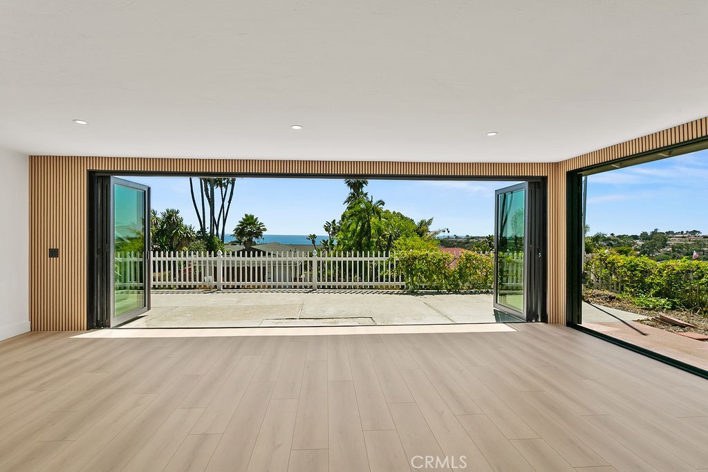 Prepare to be captivated by breathtaking Pacific Ocean views from this fully remodeled, single-level home nestled in the highly sought-after Shorecliffs community. Perched gracefully on a hillside, this coastal gem offers panoramic ocean vistas that stretch endlessly from every angle.
A grand double-door entry opens to a modern, open-concept layout that seamlessly blends indoor and outdoor living. Expansive panoramic sliding doors invite the ocean breeze inside, making it effortless to embrace the beach lifestyle year-round. The gourmet kitchen is a chef's dream, featuring a grand central island with a cooktop that faces the stunning ocean views—perfect for preparing meals while taking in the scenery. Boasting custom cabinetry, sleek stainless steel appliances (including a fridge and wine fridge), and views from both the sink and cooktop, this kitchen is designed to impress.
The spacious primary suite is a true sanctuary, soon to feature French doors that open directly onto the back patio, offering even more spectacular views. The ensuite bath includes dual sinks and a walk-in shower, making this retreat as functional as it is luxurious. Throughout the home, you'll find white oak vinyl plank flooring, recessed lighting, and designer finishes, all contributing to the bright, airy atmosphere.
For added convenience, the home features an oversized 2-car garage with extra depth, perfect for additional storage, plus in-unit laundry. Step outside to the back patio, where you'll experience some of the best ocean views this home has to offer. A rooftop deck is in the works, being redesigned and expanded to maximize those unparalleled sights—ideal for watching the waves or catching a sunset.
This home is fully equipped with modern amenities, including central A/C and energy-efficient solar panels. Plus, for those seeking additional space, a separate studio may be rented with the main house. Complete with its own kitchenette, full bath (with a grand walk-in shower), in-unit laundry, and private entrance and patio, this versatile space offers endless possibilities, whether used as a guest suite or home office. Call for rate including the studio.
Located just minutes from the ocean and with exclusive private beach club access, beach parking, tennis, and pickleball courts - this is coastal living at its finest.