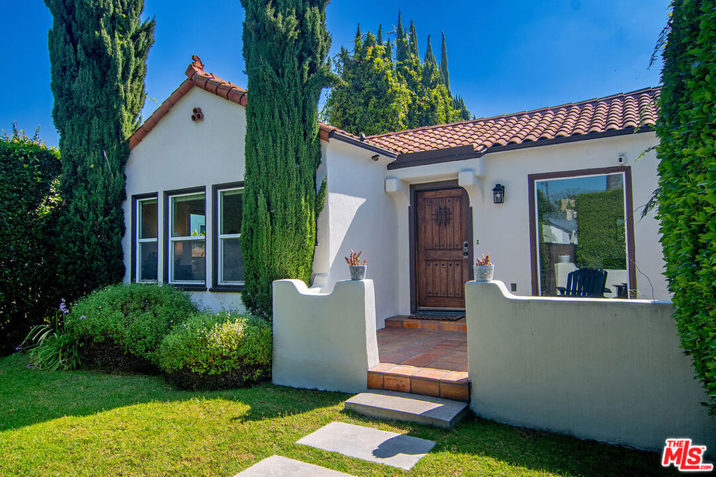STYLISH REMODELED SPANISH IN BEVERLY GROVE. Enter this fully hedged and gated ultra-private home though a front Spanish tile patio, into an expansive living room with high coved ceiling and picture window. A formal dining room adjoins a redone kitchen with stainless steel appliances, designer backsplash, tons of cabinetry and separate laundry room. A bonus office opens to the rear entertaining and dining deck and spacious yard. At the rear of the home sits the luxurious primary suite with ensuite bath, walk-in closet and sliding glass doors leading to the backyard. Additional features include central AC, a detached two car automatic garage and side driveway for ample parking, and an excellent Beverly Grove location in close proximity to Third Street, The Grove, the Beverly Center and Melrose.