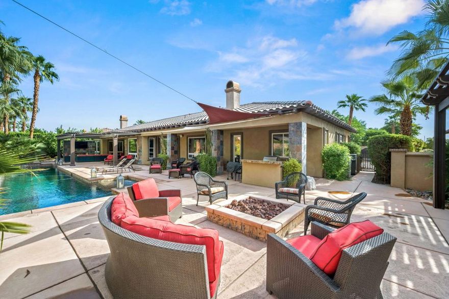 Welcome to your private desert sanctuary, an exceptional estate offering comfort, privacy and luxury in every detail. The stunning 4-bedroom, 5-bathroom main residence features expansive living spaces and exquisite finishes throughout, including a chef's kitchen with brand-new appliances, granite countertops, and ample cabinetry designed for culinary excellence.A spacious detached one-bedroom casita with its own living room provides the perfect guest retreat or private office space.Step outside to a resort-style backyard complete with a 60-foot saltwater lap pool, ideal for both leisure and fitness. The fully landscaped grounds offer serene desert beauty, while multiple outdoor lounging areas invite relaxation and entertainment.The oversized primary suite is a true retreat, showcasing a dual-sided fireplace, sitting area, and two generous walk-in closets. Two additional guest bedrooms offer en-suites and a fourth guest bedroom creates a perfect blend of elegance and functionality.Additional highlights include an attached 3-car garage plus a separate detached 2-car garage ideal for car enthusiasts or extra storage. The entire estate is immaculately maintained, with a rare combination of modern amenities, timeless style, and unmatched privacy.Experience the ultimate in desert luxury, schedule your private showing today.