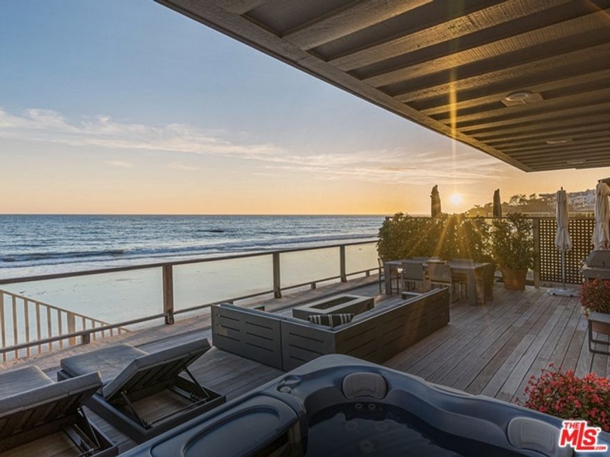 Spectacular ocean & coastline views from this California 2-story home with 40' of frontage.  This 3 bedroom, 3 bath property opens on the main level to a sun-filled great room with breathtaking  ocean views, living/media area, dining area, open kitchen & additional seating area with fireplace seamlessly flowing out to the wooden deck complete with hot tub & fire pit for relaxing, reading & entertaining. Steps down to the beach, take in the surf & enjoy a glorious ocean sunset.  The entire upper level is dedicated to the spacious owners retreat featuring high, vaulted ceilings, 2 separate bathrooms, 2 separate walk in closets, a private ocean-view deck & stone fireplace with seating area. The main level has 2 additional bedrooms with full bath & guest powder room. Detached 2-car garage with built in storage & guest parking. A terrific beach house located on one of the most beautiful beaches in Malibu.